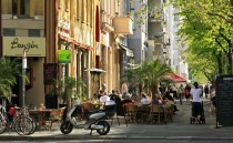 Street with people in coffee shops